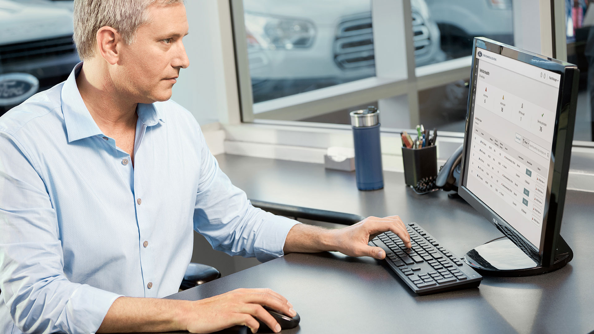 Man sitting at desk with screen